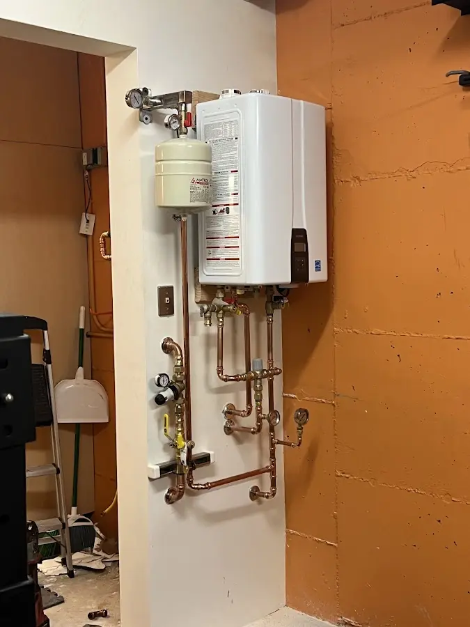 Plumbing technician inspecting water heater connections in Ridge Wood Heights